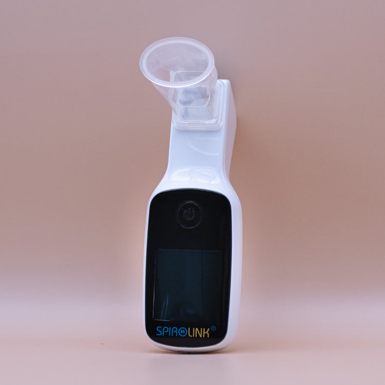 Handheld spirometer device with mouthpiece, labeled "SPIROLINK", used for measuring lung function.