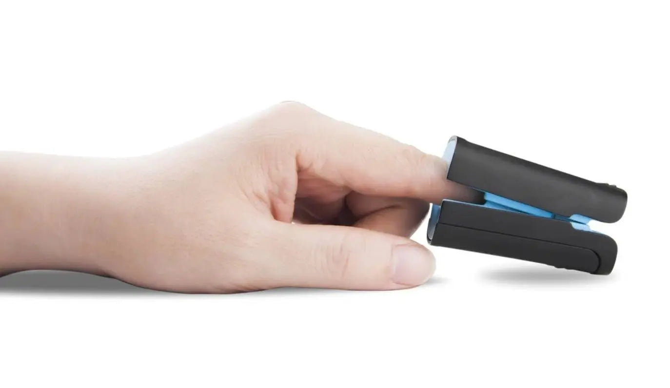 Close-up image of a fingertip pulse oximeter clipped onto a finger to measure blood oxygen saturation and heart rate.